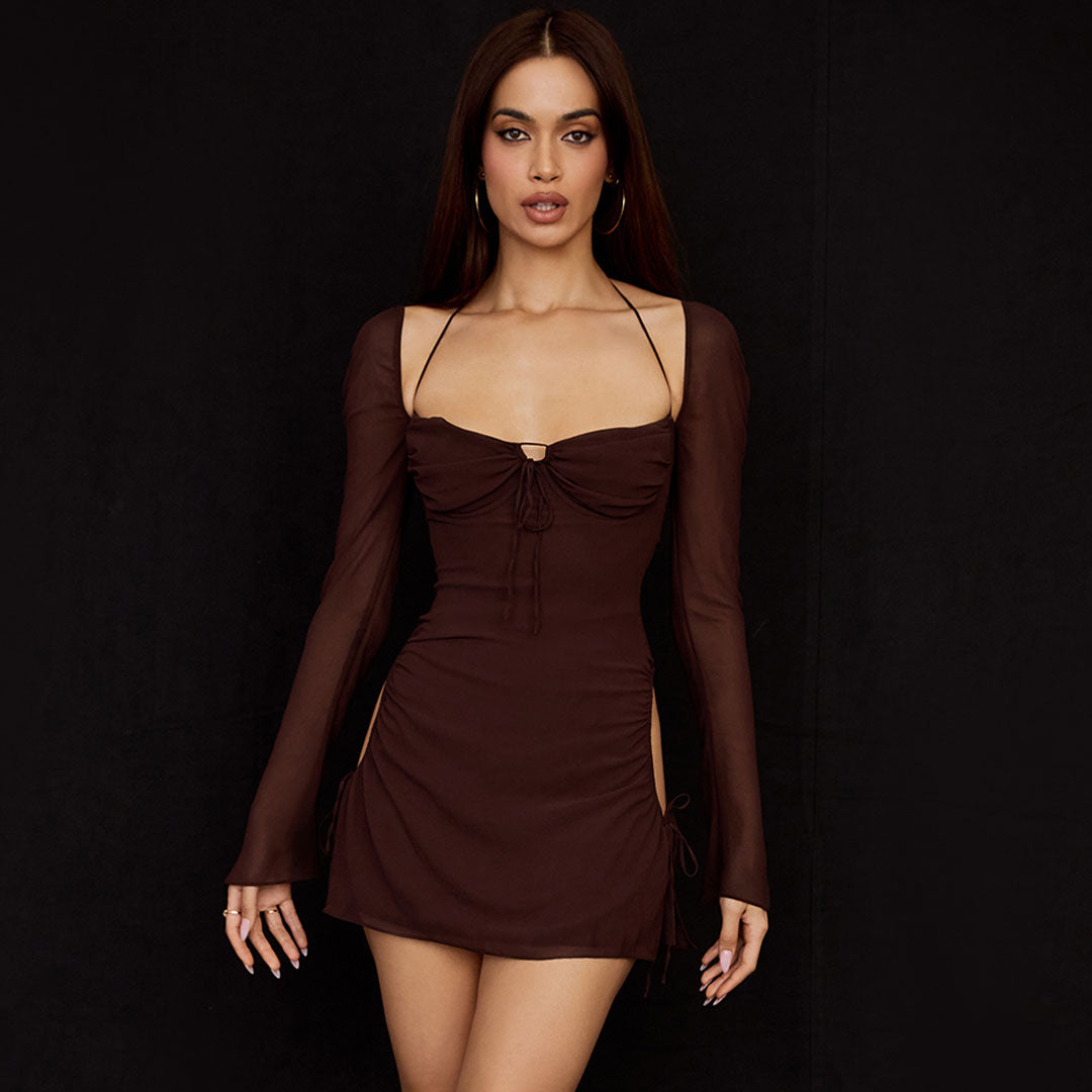 Woman wearing a brown sheer mesh mini dress with long bell sleeves and cut-out sides.