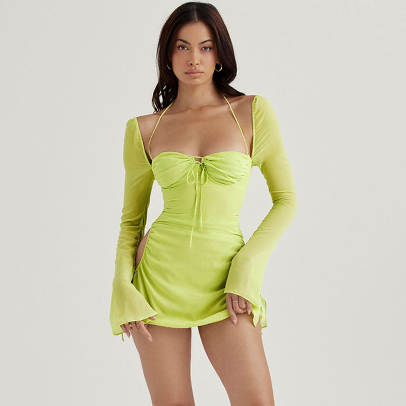 Woman wearing a lime green sheer mini dress with halter neckline and long bell sleeves, front view