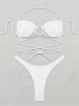 Flat lay of a white strappy bikini top and bottoms