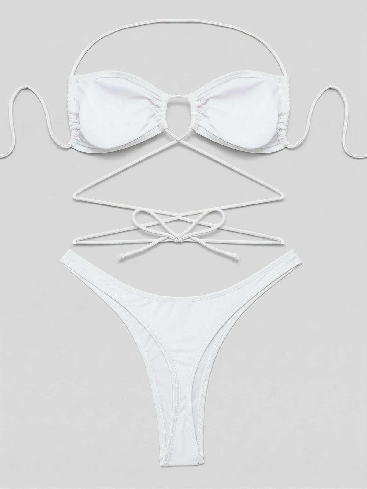 Flat lay of a white strappy bikini set with ties