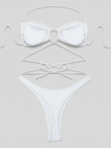 Flat lay of a white strappy bikini set with ties