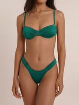 Woman wearing a forest green ruched bikini set