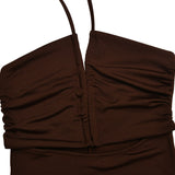 Close-up of the ruched bodice of a brown halter neck maxi dress.