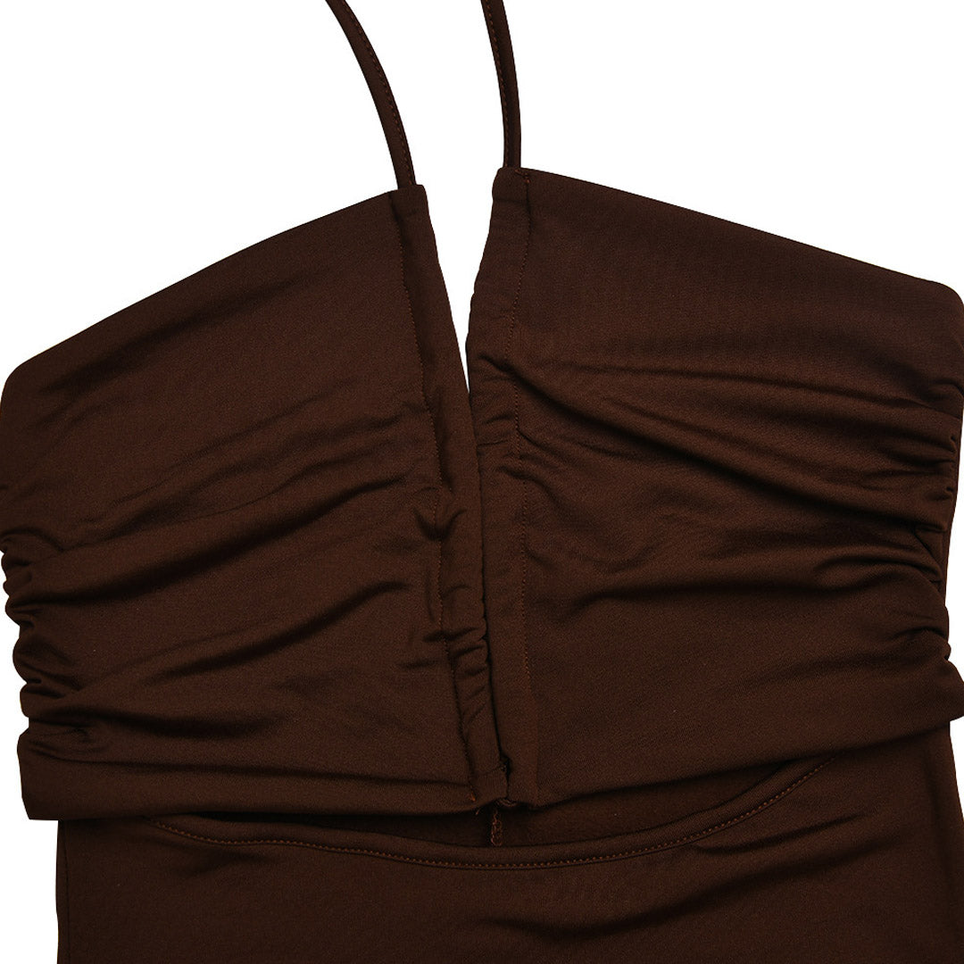 Close-up of the ruched bodice of a brown halter neck maxi dress.