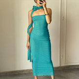 Full-body shot of a woman in a teal strapless mesh column dress with ruching and an asymmetrical strap.