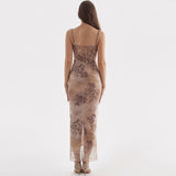 Back view of a woman in a long, sheer, floral and leopard print dress with a lace-up back detail.