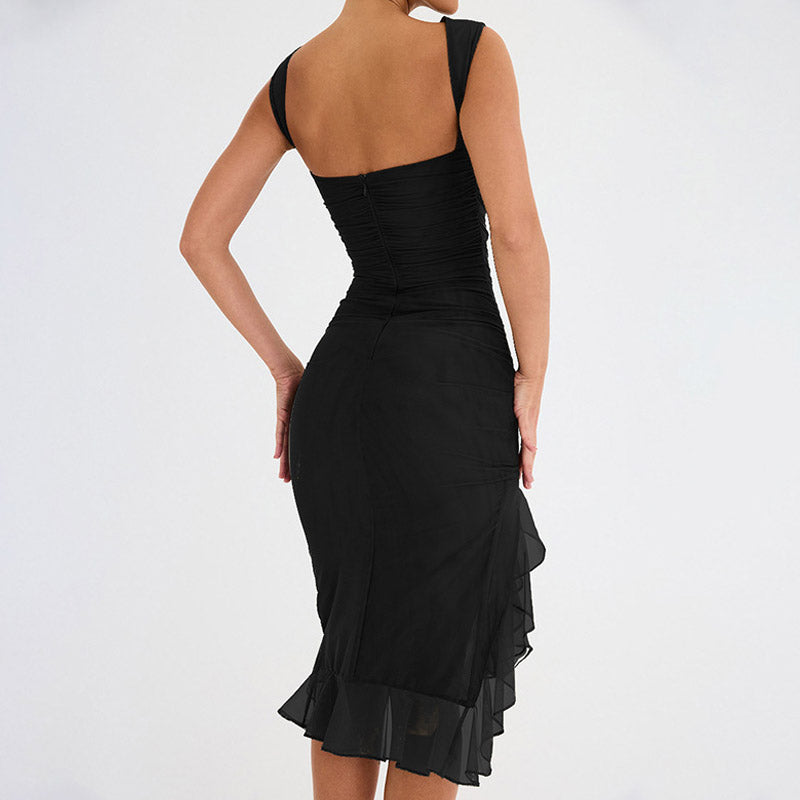 Back view of a woman in a black sleeveless ruched mesh dress.
