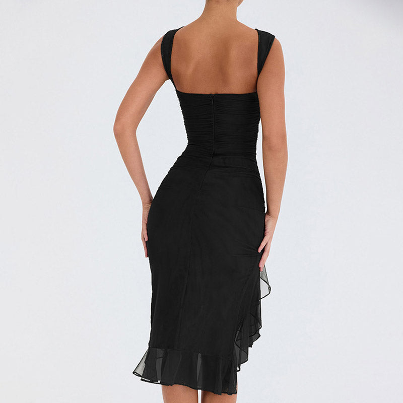 Detail of the ruffled hem on a black mesh dress.