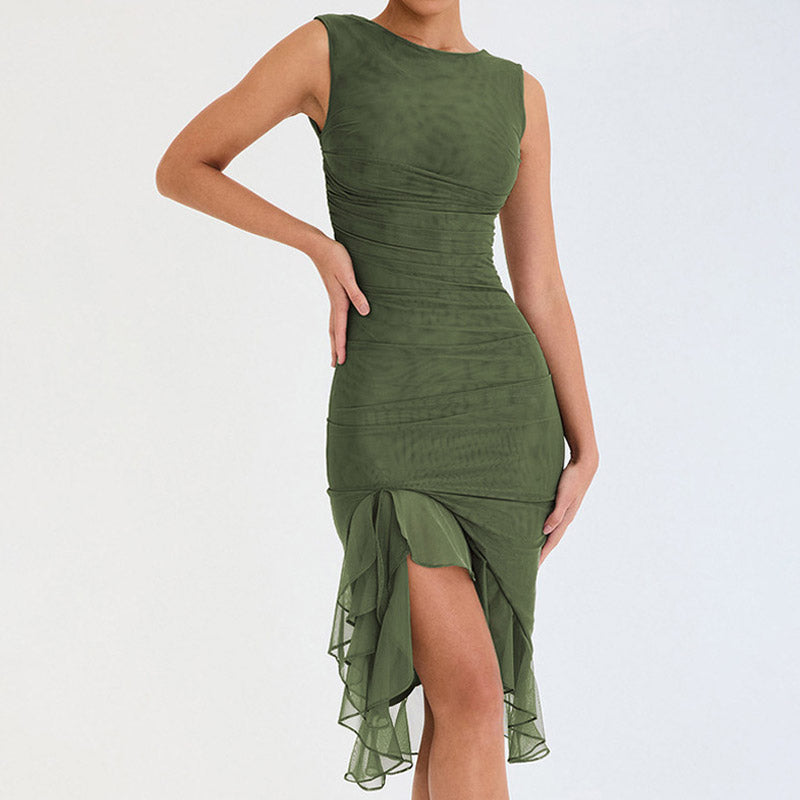 Model wearing a green sleeveless ruched mesh dress with a ruffled asymmetrical hem, front view.