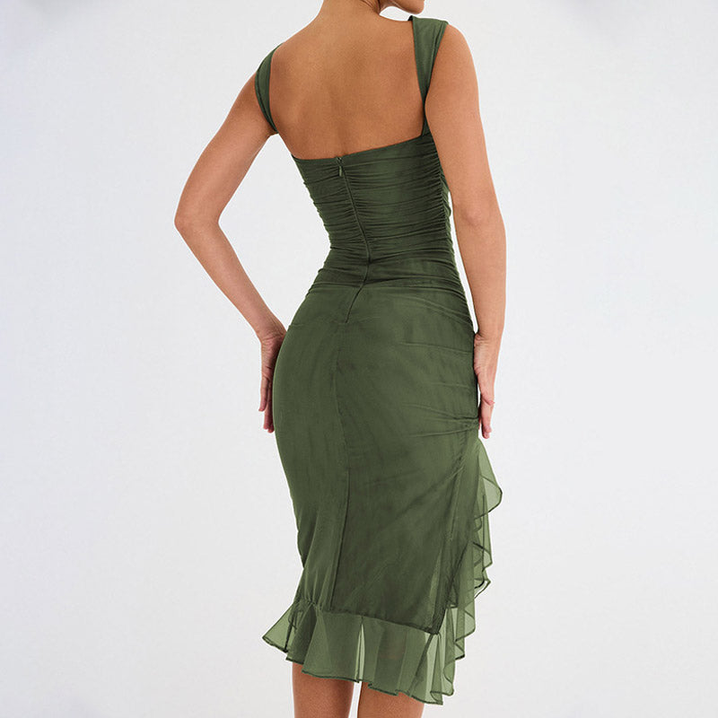 Model wearing a green sleeveless ruched mesh dress with a ruffled asymmetrical hem, back view.