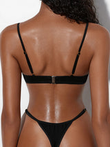 Back view of a black two-piece set showing the closure and strap details.