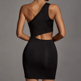 Back view of a woman wearing a black one-shoulder mini dress with cut-outs.
