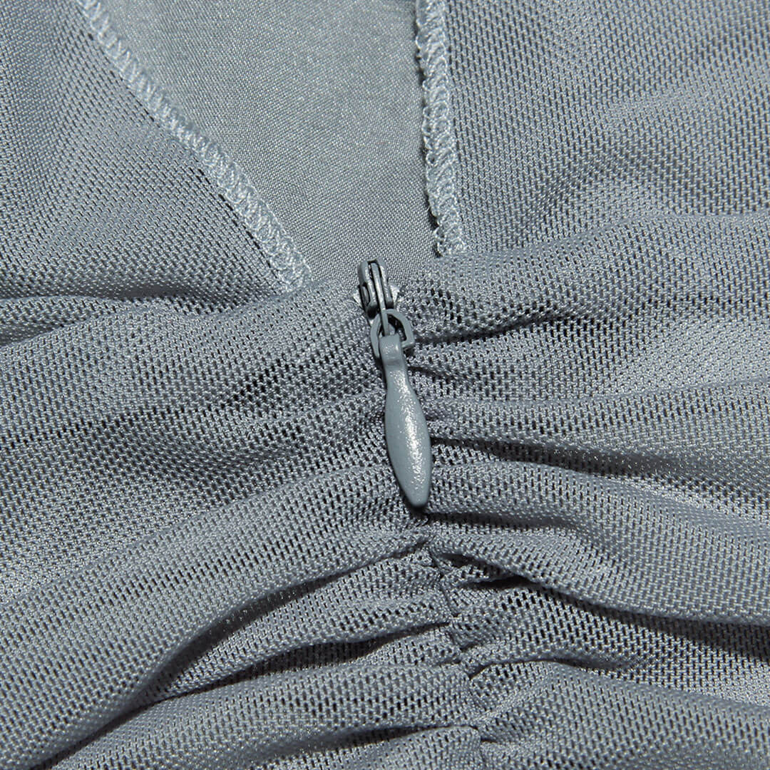 Close-up of the mesh fabric and zipper on the grey dress.