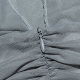 Close-up of the mesh fabric and zipper on the grey dress.