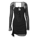 A flat lay of a black sheer mesh mini dress with corset detailing and long sleeves.