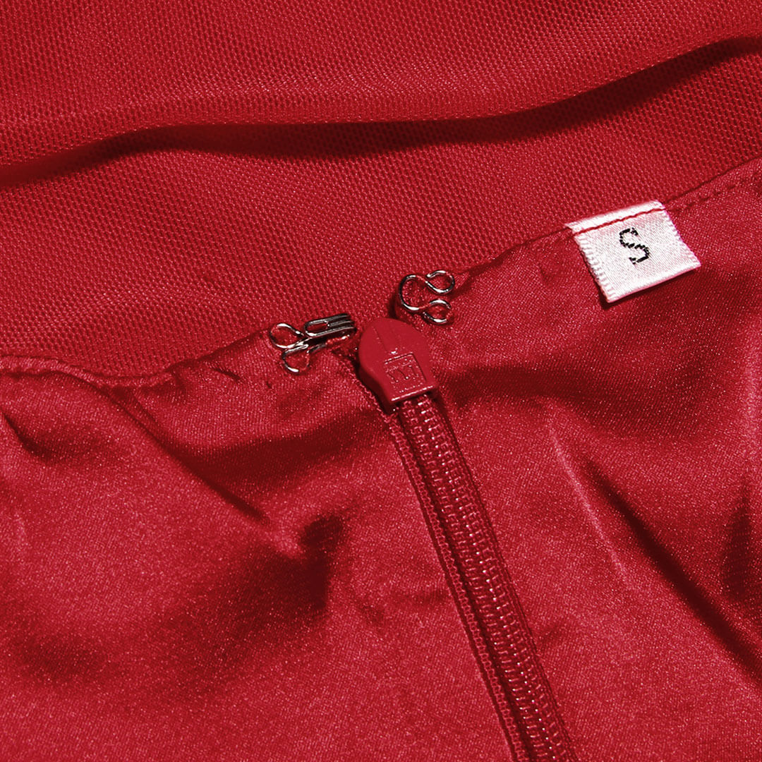 Close-up of the zipper and size tag on a red dress