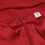 Close-up of the zipper and size tag on a red dress