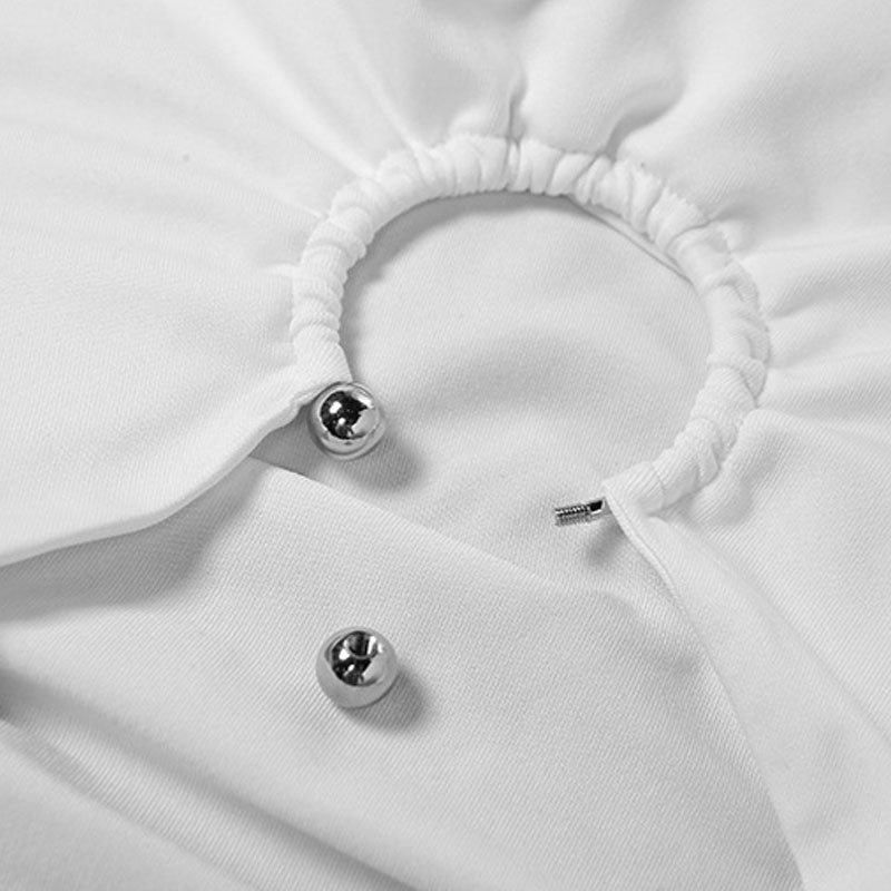 Close-up of a white garment showing a metal ring detail and ruched fabric