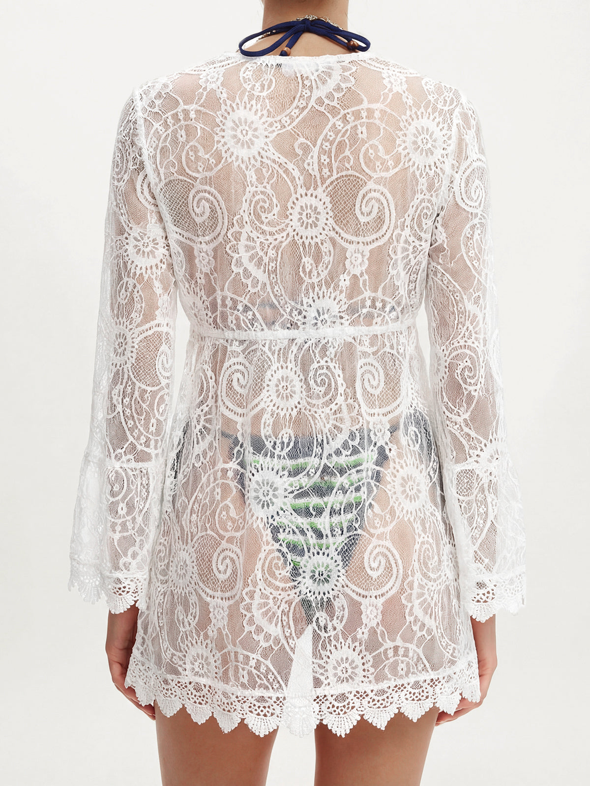 back view of a white lace cover-up worn over swimwear