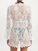 back view of a white lace cover-up worn over swimwear