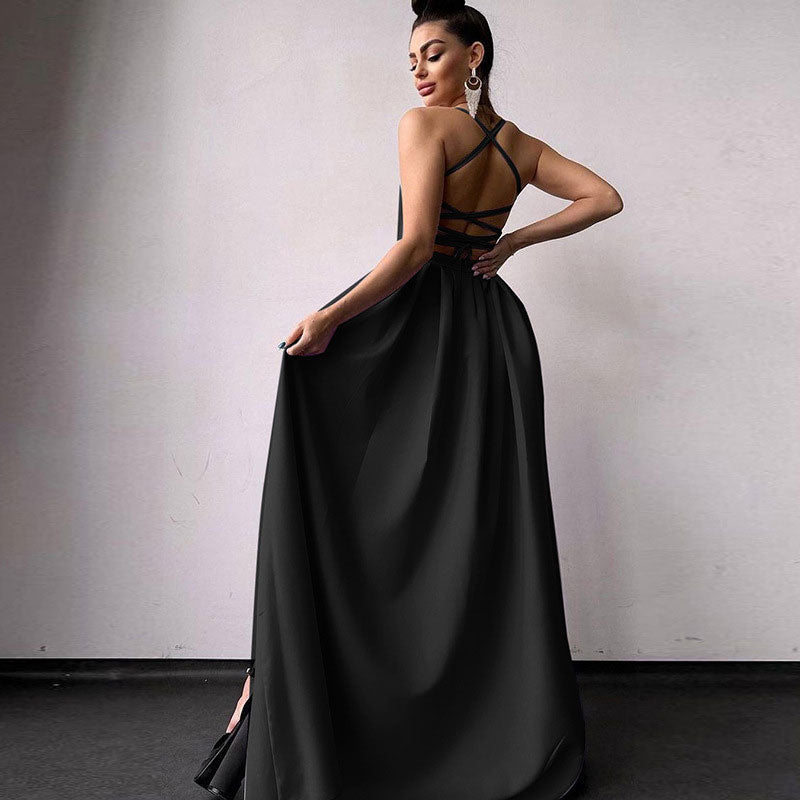 Back view of a woman in a black satin formal gown showing the strappy detail