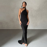 woman wearing a black one-shoulder halter neck maxi dress with a draped train