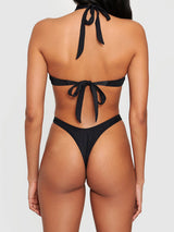 Back view of a black one-piece swimsuit with a thong bottom and halter neck