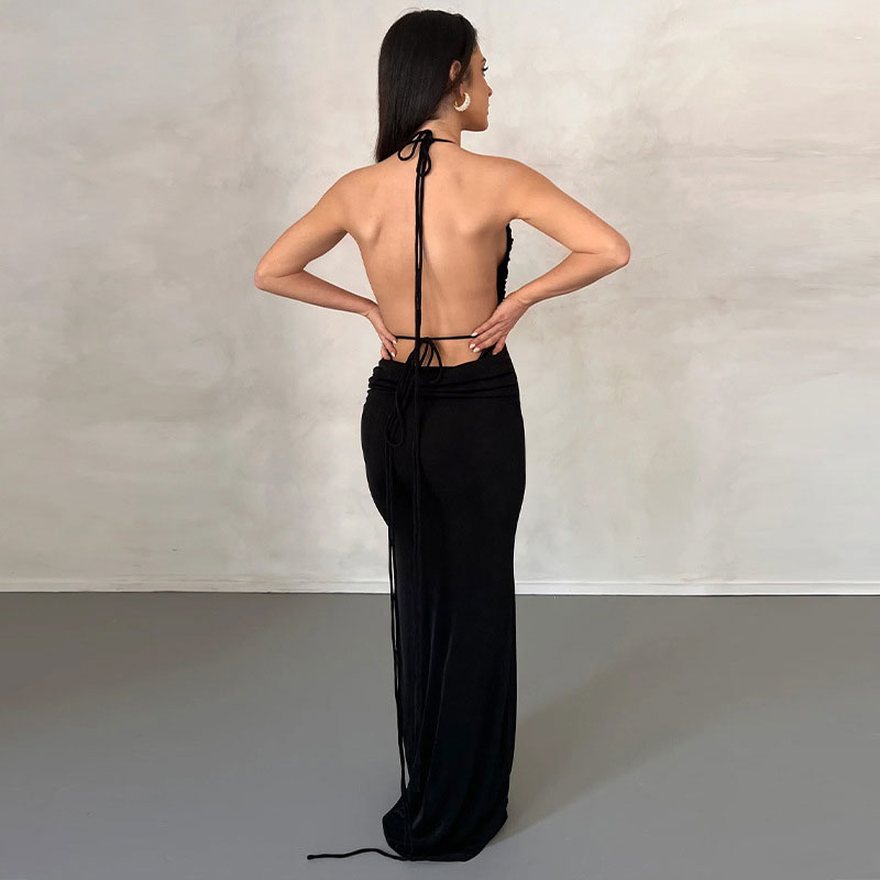back view of a woman in a long black dress with an open back and tie straps