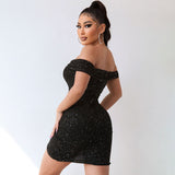 Back view of a woman wearing a black off-the-shoulder sparkly mini dress with ruched detailing and an asymmetrical hemline.