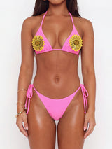 Front view of a pink bikini with sunflower embellishments