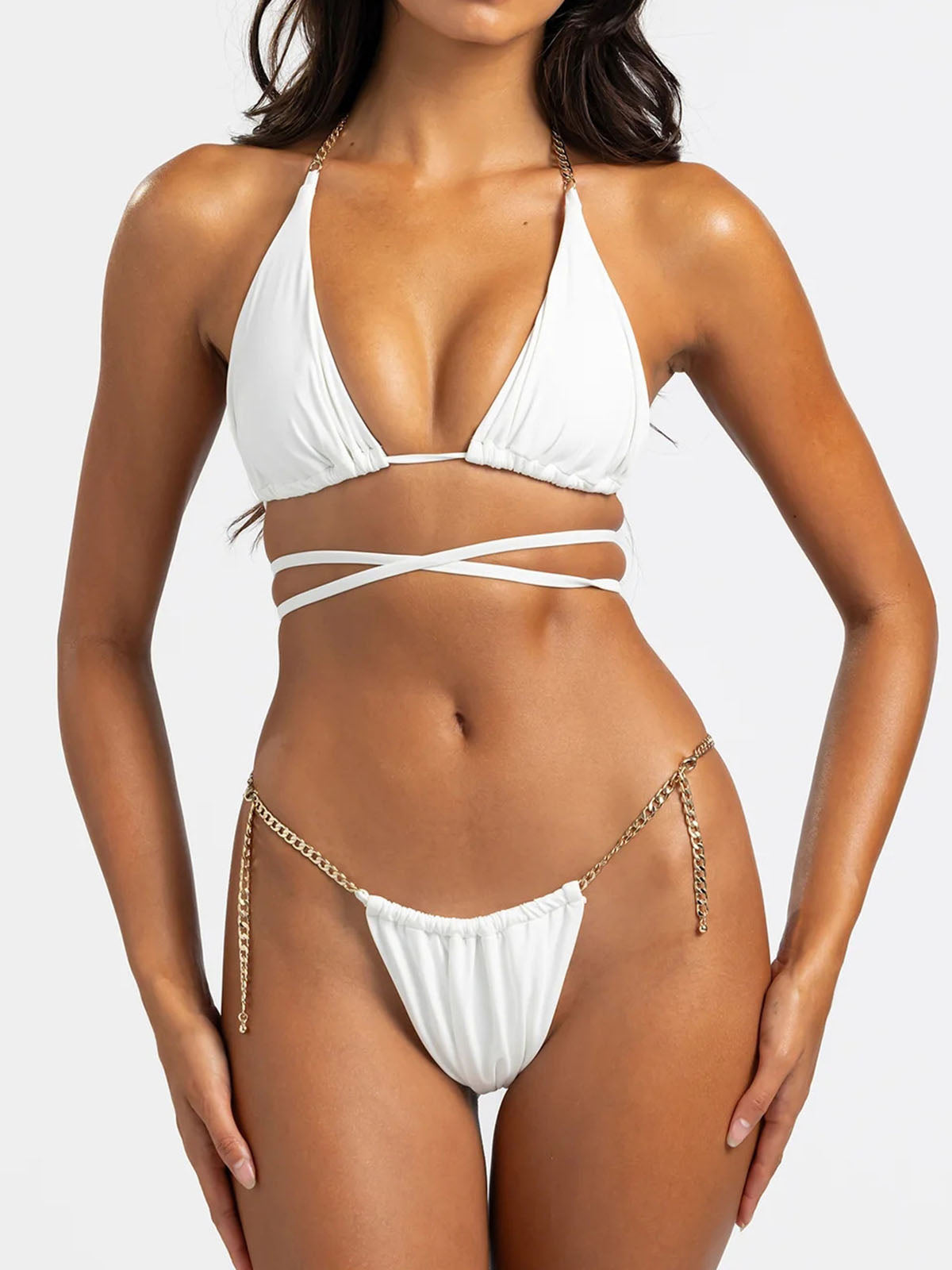 Front view of a white bikini set with gold chain detailing
