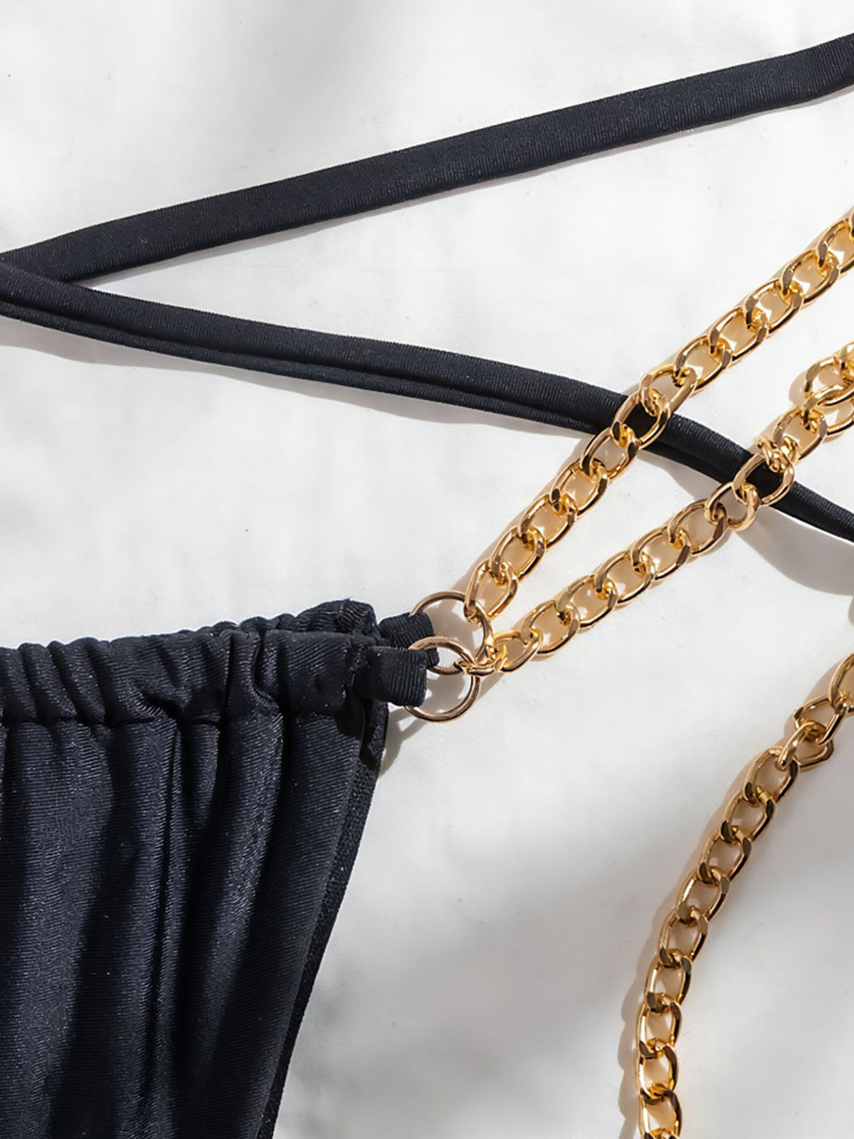 Close-up of the gold chain detail on the bikini bottoms
