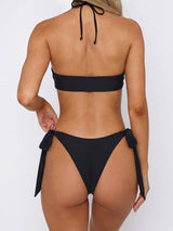 Back view of a black halter bikini with adjustable side ties