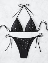Black bikini top and bottom with sparkle embellishments laid flat
