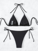 Inside view of a black bikini top and bottom laid flat