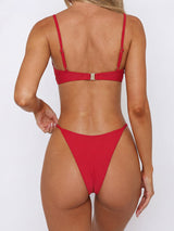 Red bikini bottom with gold-tone embellishments at the hips.