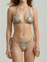 Front view of a woman wearing a snake print bikini with gold hardware