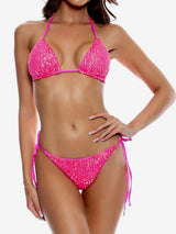 Woman wearing a hot pink sequined bikini against a white background