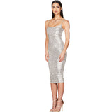 Woman wearing a silver sequined midi dress with spaghetti straps, side view.