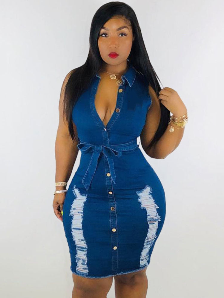 woman wearing a distressed denim sheath dress with a v-neck and belted waist, posing