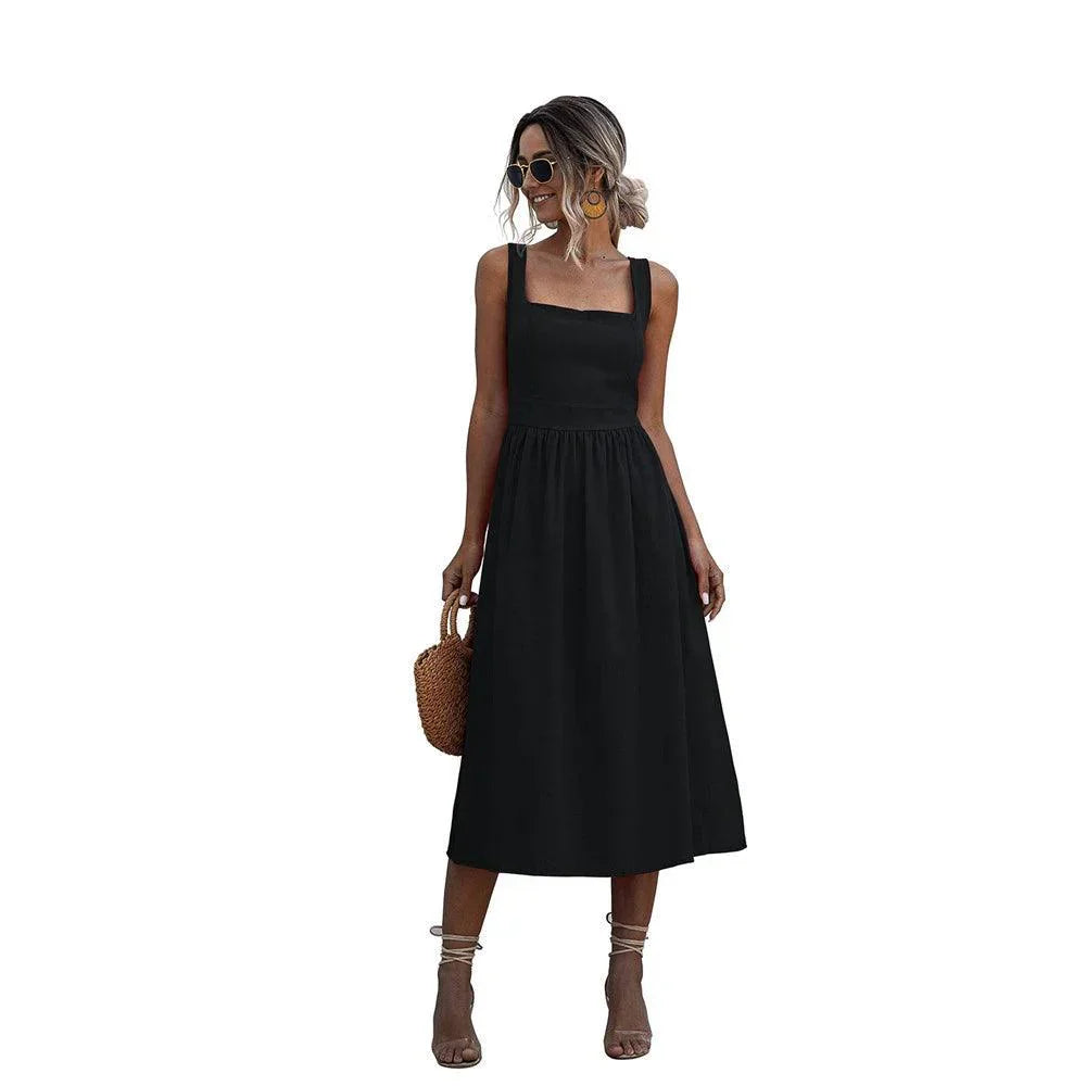 Woman wearing a black sleeveless square neck midi dress with a fitted bodice and A-line skirt.
