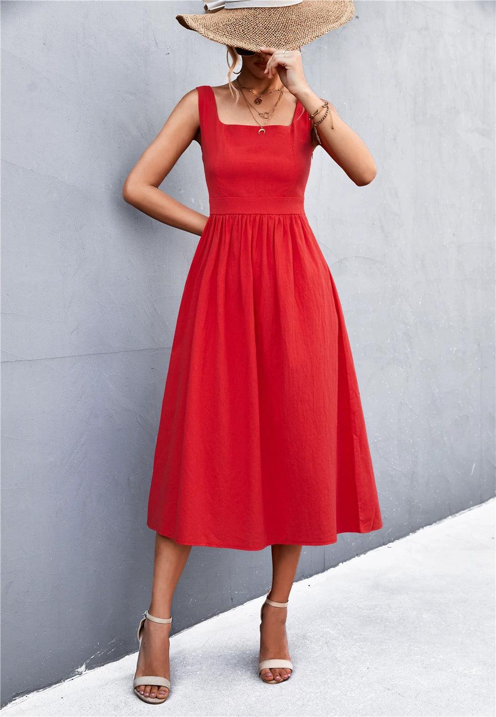 Woman wearing a red sleeveless square neck midi dress with a fitted bodice and A-line skirt.