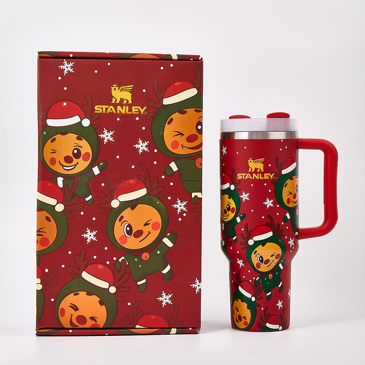 Red Stanley tumbler and matching gift box with holiday reindeer design