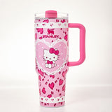 Pink Stanley tumbler with Hello Kitty graphic and heart pattern