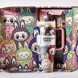 Open gift box revealing the Stanley Quencher H2.0 Tumbler surrounded by cartoon character illustrations