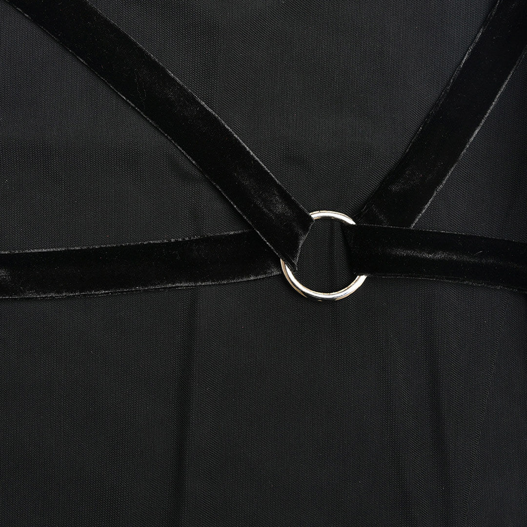 Detail of the velvet straps and metal ring accent on the bodice of a black sheer mesh dress.