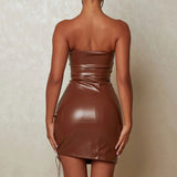 Back view of a woman in a brown strapless faux leather bodycon dress