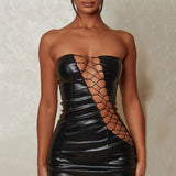 Side view of a black strapless faux leather dress with cut-out accents