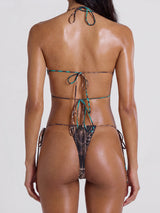 Back view of a woman wearing a patterned bikini set with adjustable tie closures.