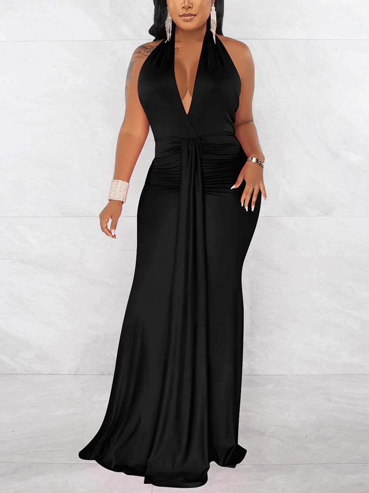 Woman wearing a long black halter dress with a deep V-neckline and ruched waist